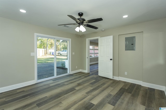 unfurnished room featuring electric panel, dark hardwood / wood-style floors, and ceiling fan