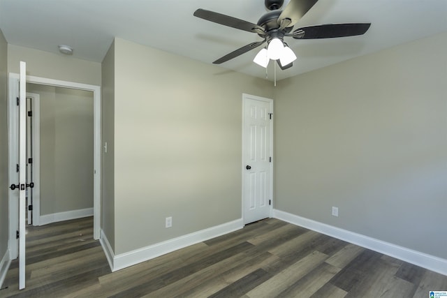 unfurnished bedroom with dark hardwood / wood-style flooring, a closet, and ceiling fan