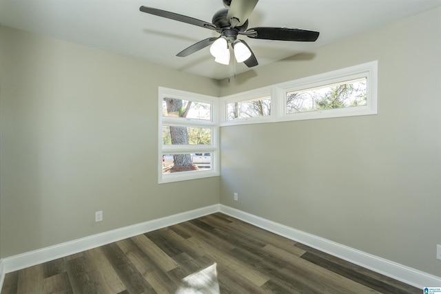 empty room with ceiling fan, dark hardwood / wood-style flooring, and a wealth of natural light