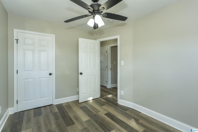 unfurnished bedroom featuring ceiling fan, dark hardwood / wood-style floors, and a closet