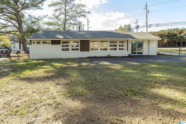 rear view of house featuring a lawn