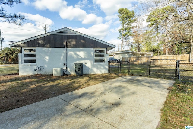 view of side of home with central AC