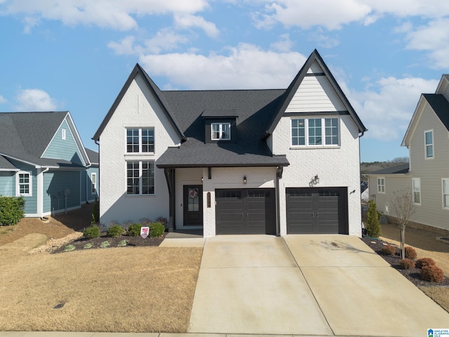 view of front of house with brick siding, driveway, and an attached garage