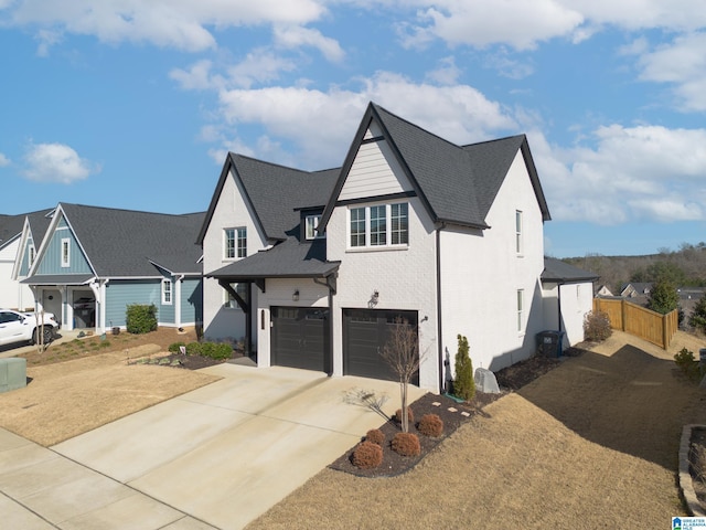 view of front of home with a garage, a residential view, brick siding, and driveway