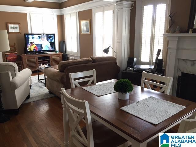 dining space with hardwood / wood-style flooring, plenty of natural light, and a fireplace