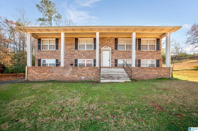 split foyer home featuring covered porch and a front yard