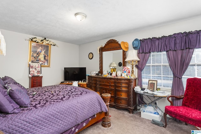 bedroom with light colored carpet and a textured ceiling