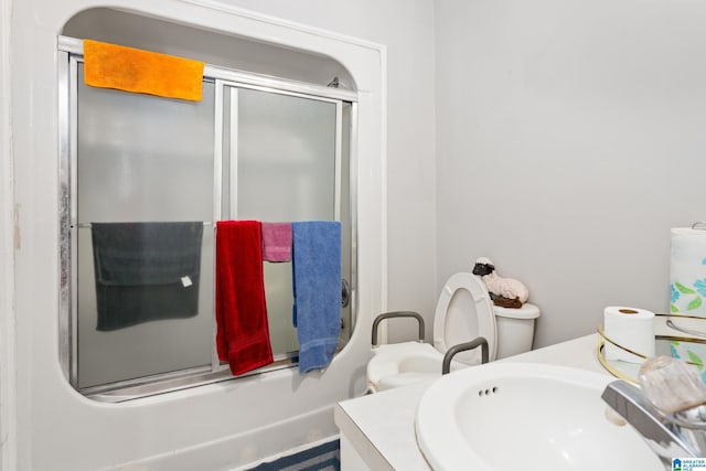 full bathroom featuring shower / bath combination with glass door, toilet, and sink