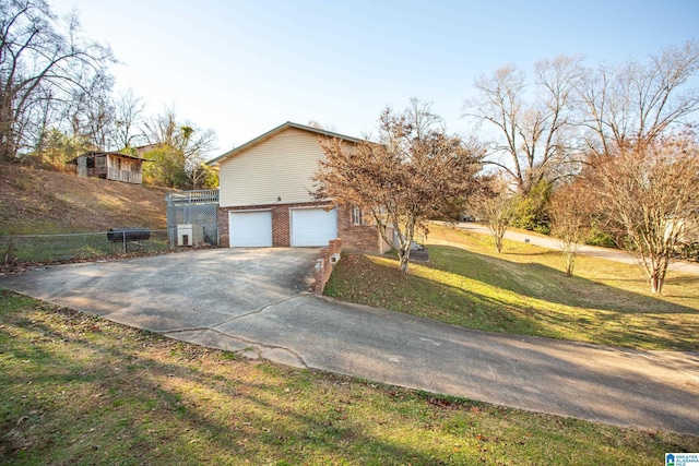 view of property exterior featuring a lawn and a garage