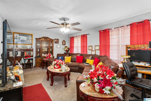 living room with a textured ceiling, ceiling fan, and light carpet