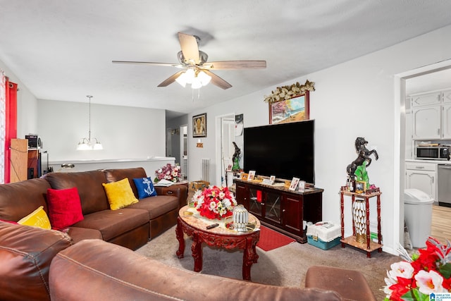 living room with ceiling fan with notable chandelier