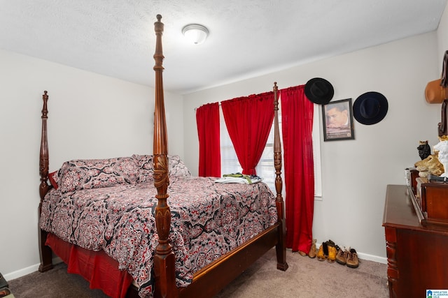 bedroom featuring carpet and a textured ceiling