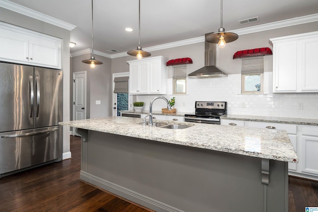 kitchen featuring sink, wall chimney range hood, dark hardwood / wood-style floors, a center island with sink, and appliances with stainless steel finishes