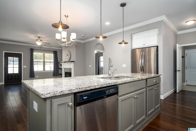 kitchen featuring sink, hanging light fixtures, dark hardwood / wood-style flooring, an island with sink, and appliances with stainless steel finishes