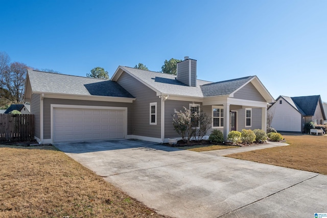 ranch-style house featuring a garage and a front lawn