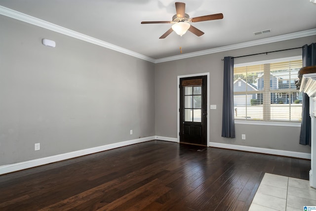 interior space with ceiling fan, crown molding, dark wood-type flooring, and a tile fireplace