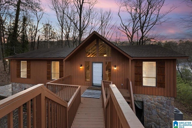 view of front facade with central AC and a wooden deck