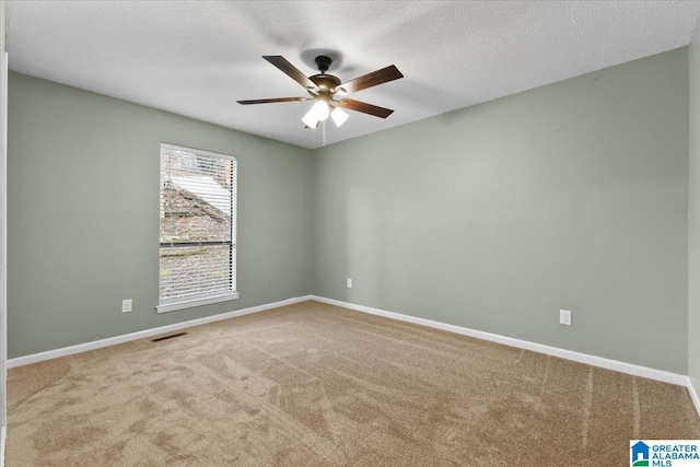 unfurnished room featuring carpet flooring, ceiling fan, and a textured ceiling