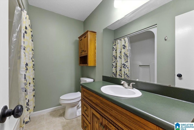 bathroom featuring tile patterned floors, vanity, toilet, and a textured ceiling