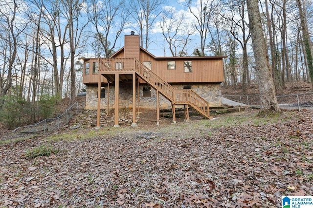 back of house featuring a wooden deck