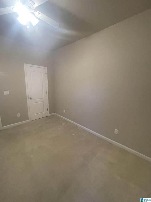 carpeted spare room featuring ceiling fan