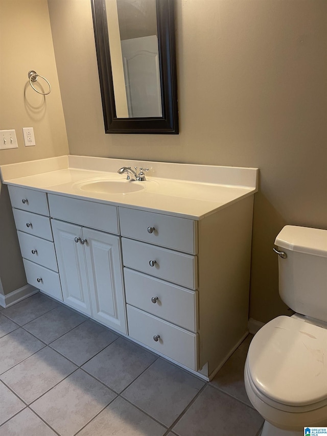 bathroom with tile patterned flooring, vanity, and toilet