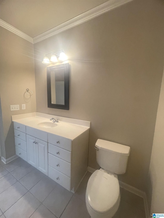 bathroom with tile patterned floors, toilet, vanity, and ornamental molding