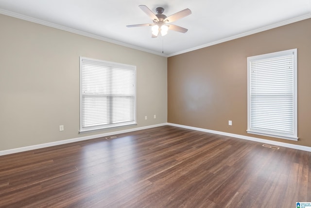 unfurnished room featuring ornamental molding, plenty of natural light, ceiling fan, and dark hardwood / wood-style flooring