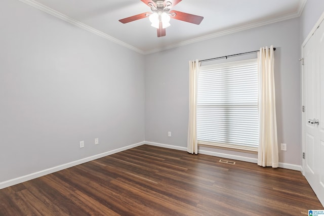 empty room with ceiling fan, a healthy amount of sunlight, ornamental molding, and dark hardwood / wood-style flooring