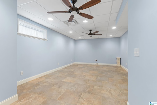 spare room featuring ceiling fan and a drop ceiling