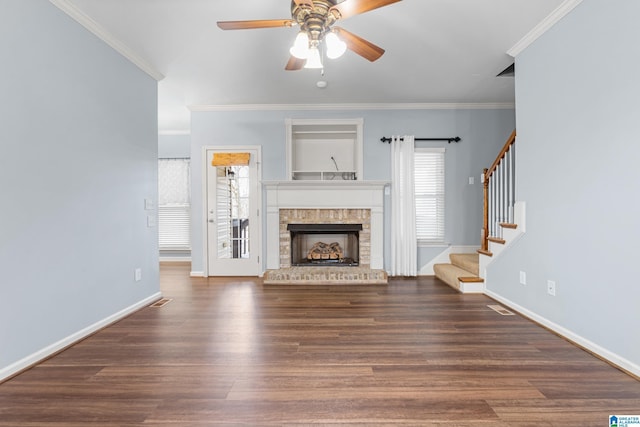 unfurnished living room featuring ceiling fan, dark hardwood / wood-style flooring, a brick fireplace, and ornamental molding