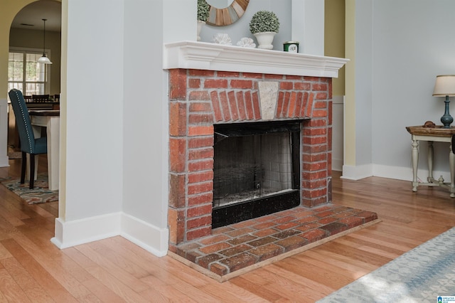 details with a fireplace and wood-type flooring