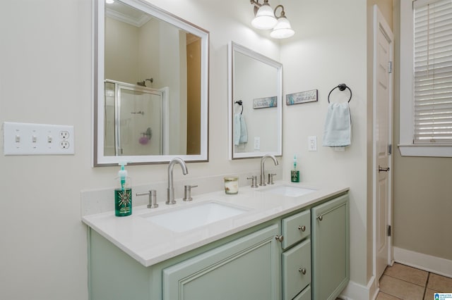 bathroom with vanity, tile patterned floors, a shower with shower door, and crown molding