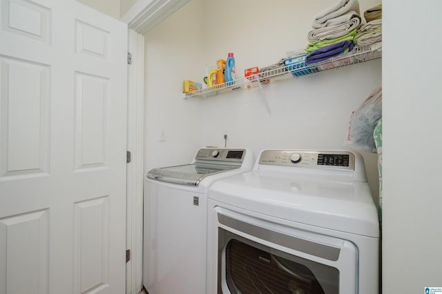 clothes washing area featuring washing machine and clothes dryer