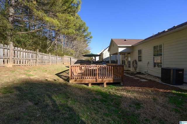 view of yard featuring central air condition unit and a deck