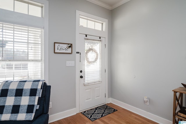 entryway featuring hardwood / wood-style flooring and crown molding