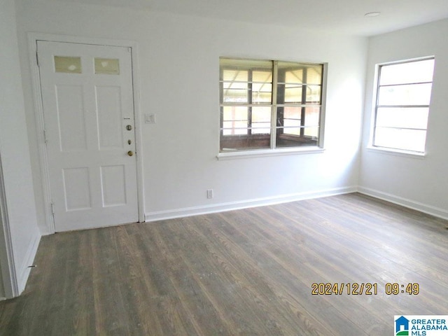 foyer featuring baseboards and wood finished floors