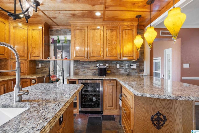 kitchen featuring light stone countertops, a center island, beverage cooler, backsplash, and decorative light fixtures