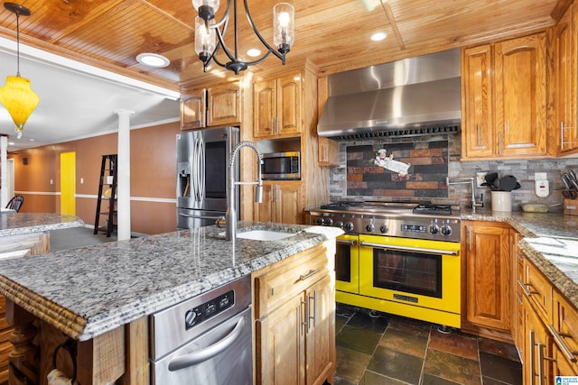 kitchen with backsplash, stainless steel appliances, sink, wall chimney range hood, and a center island