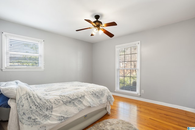 bedroom with hardwood / wood-style floors and ceiling fan