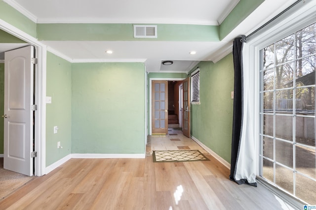 corridor with crown molding and light wood-type flooring