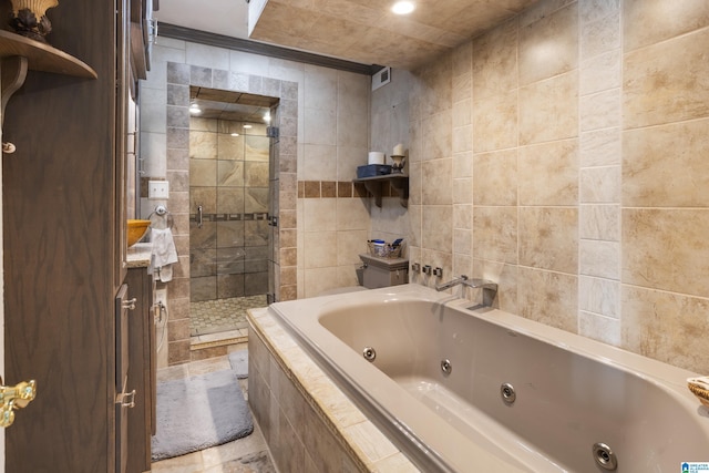 bathroom with plus walk in shower, tile walls, and ornamental molding