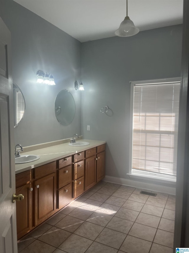 bathroom with tile patterned flooring and vanity