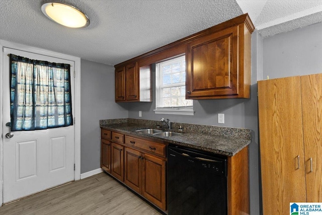 kitchen with baseboards, light wood-type flooring, black dishwasher, a textured ceiling, and a sink