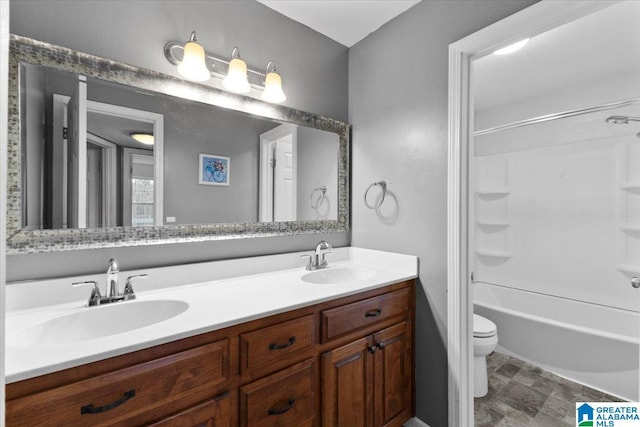 bathroom with double vanity, toilet, washtub / shower combination, and a sink