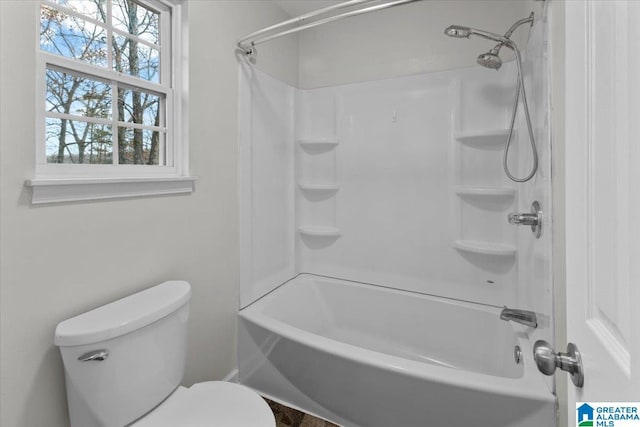 bathroom with shower / bathing tub combination and toilet