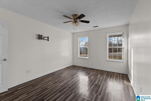 empty room with a textured ceiling, ceiling fan, and dark wood-type flooring