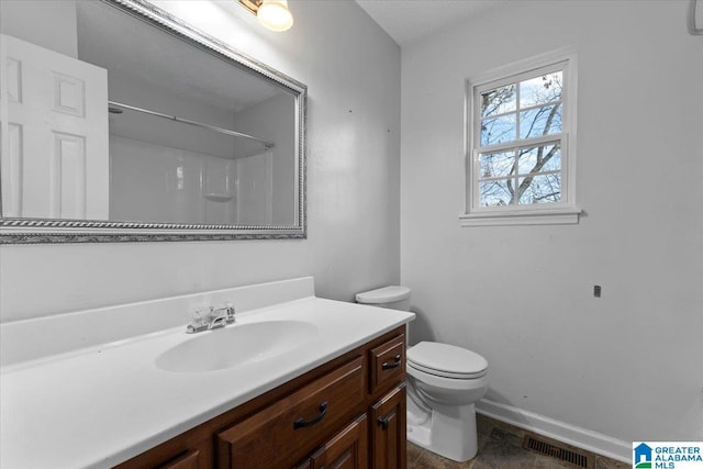 full bathroom featuring visible vents, toilet, baseboards, walk in shower, and vanity