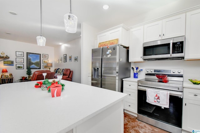 kitchen featuring hanging light fixtures, white cabinets, and stainless steel appliances