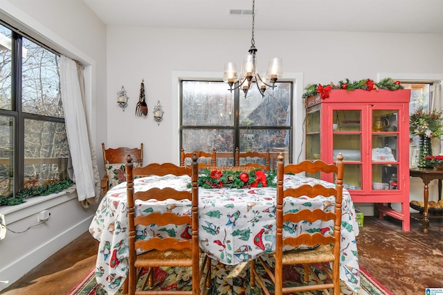 dining area with a notable chandelier and a wealth of natural light